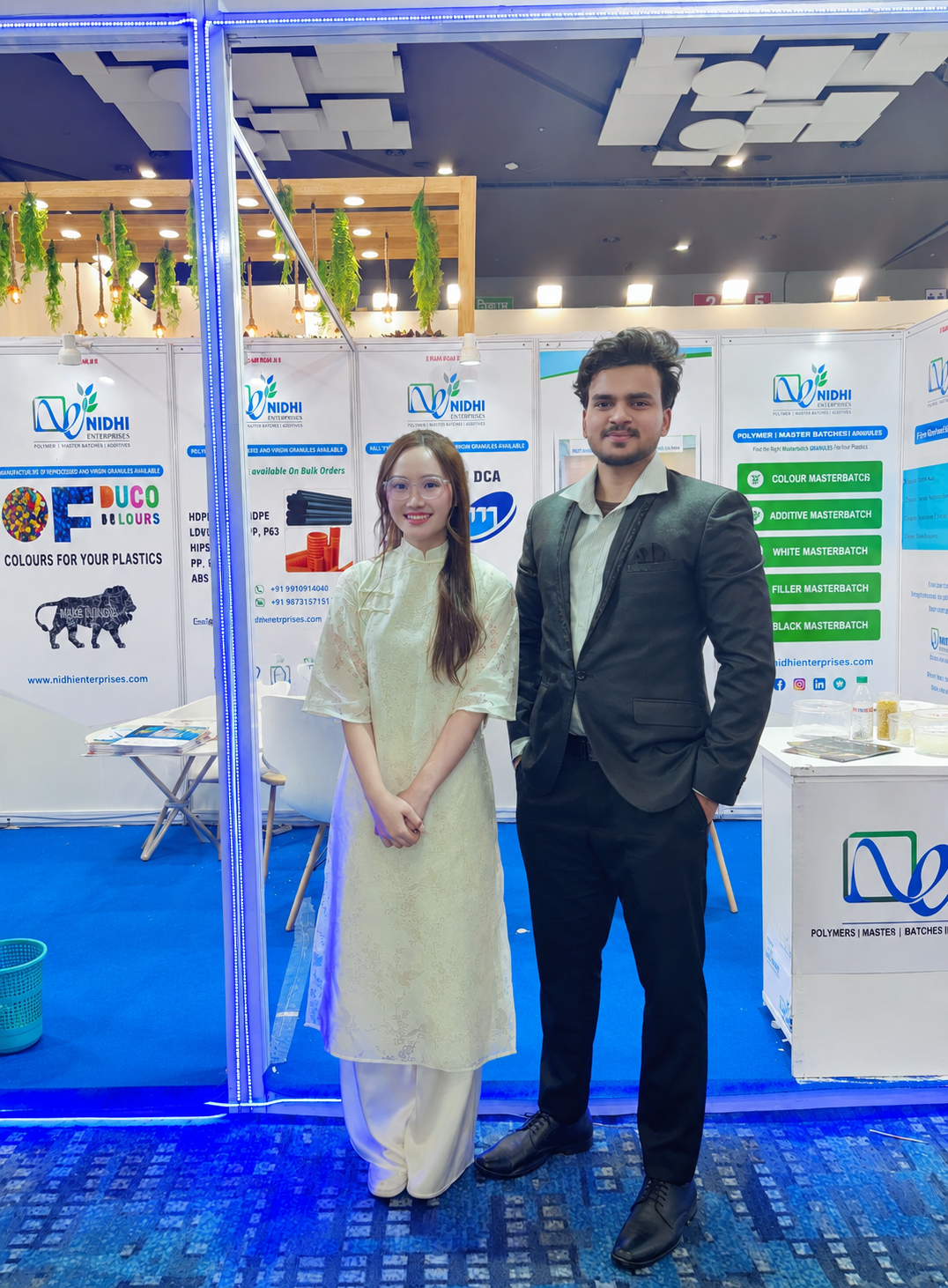 Nikhil Singh with a Vietnamese trade visitor at a polymer exhibition booth